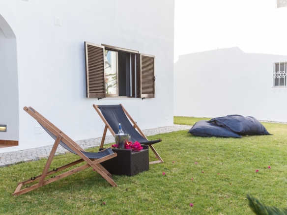 summer apartment garden with chairs and pillows setup